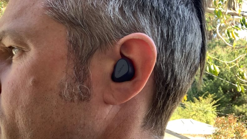 The Jabra Elite 4 headset inside a person's ear.