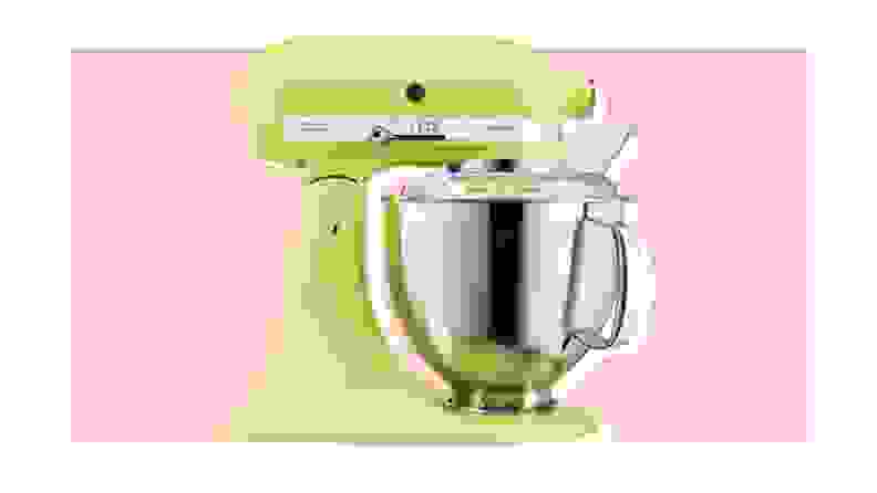 Green KitchenAid stand mixer on pink background