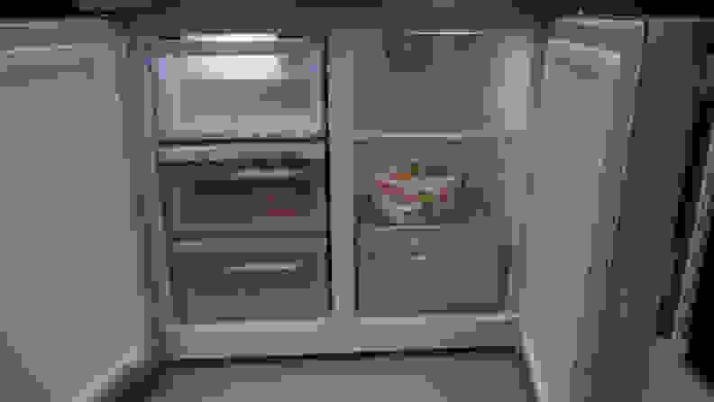 A close-up of the freezer. The left compartment has three drawers and the right compartment has one drawer underneath two shelves.