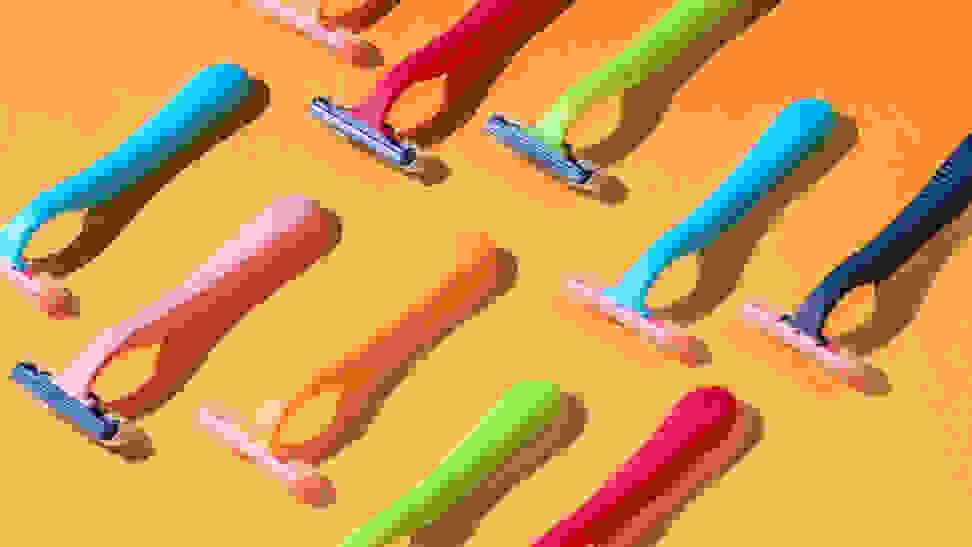 Two rows of colorful razors lay atop an orange background.