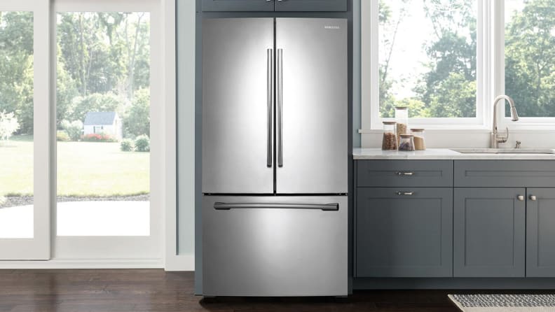 The Samsung RF260BEAESR French-door refrigerator, installed in a modern kitchen that's full of windows letting light in from the backyard.