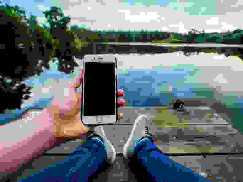 Smartphone on deck by lake