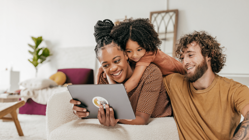 family looking at laptop