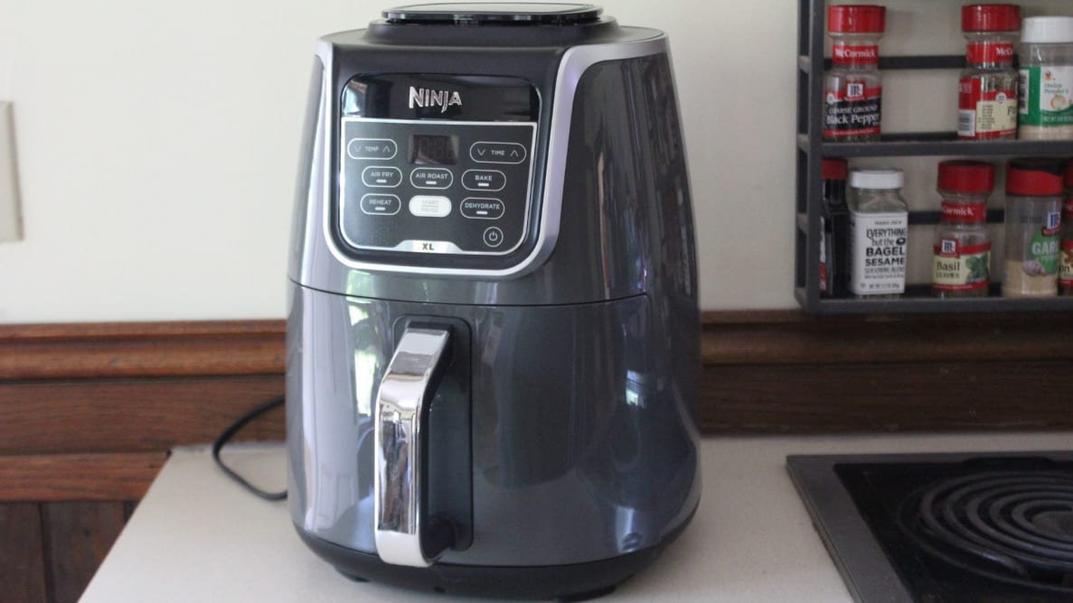 The Ninja Air Fryer XL standing on display atop a table.