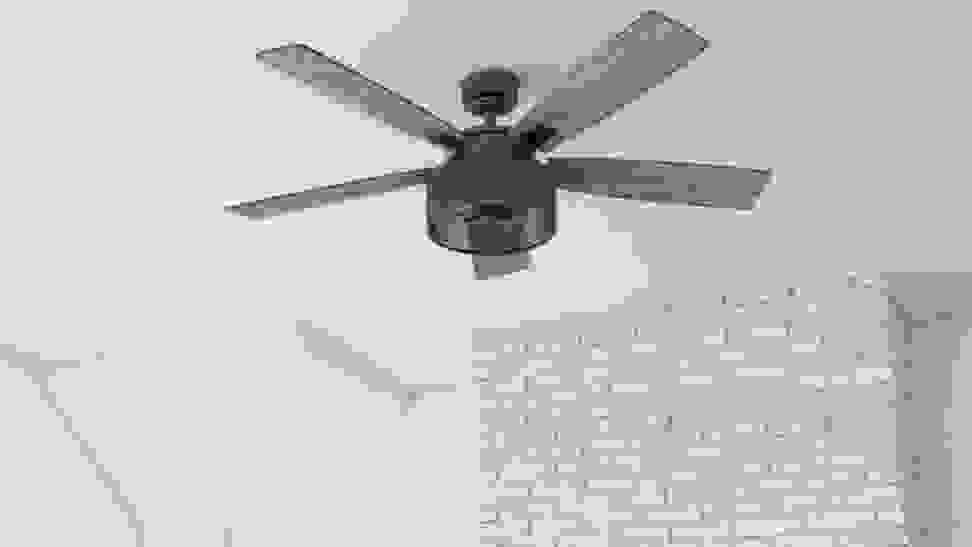A ceiling fan hanging from a white ceiling.