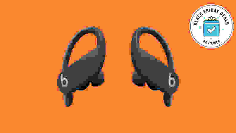 A pair of Powerbeats Pro wireless earphones with the Black Friday Deals Reviewed badge in front of a colored background.