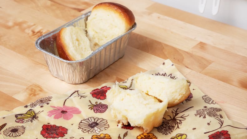 Slices of bread wrapped in reusable produce bags on top of a counter.