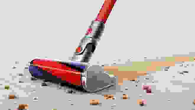A Dyson vacuum sucks up spilled cereal.