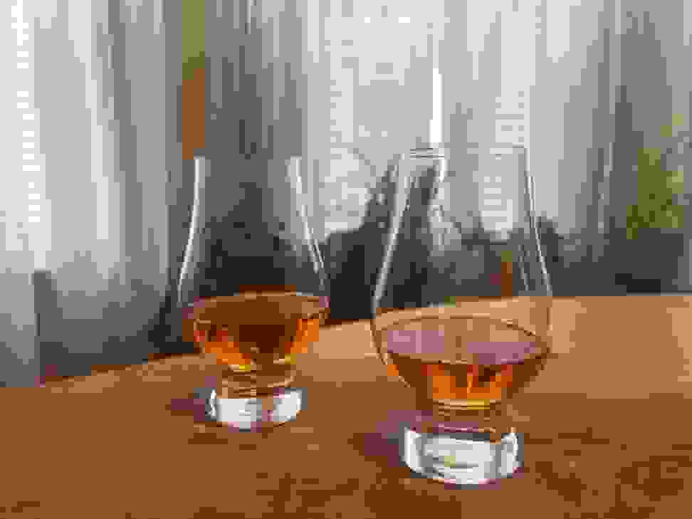 Two glasses of whiskey in Glencairn whiskey glasses.