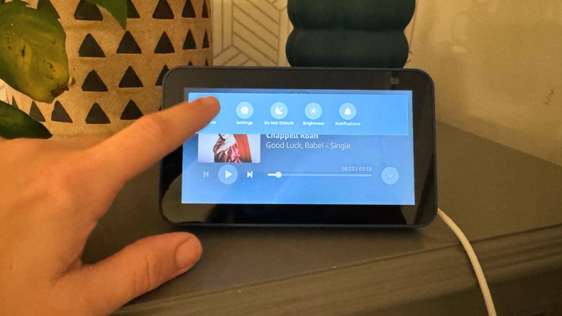 A hand touching the Echo Show 5.