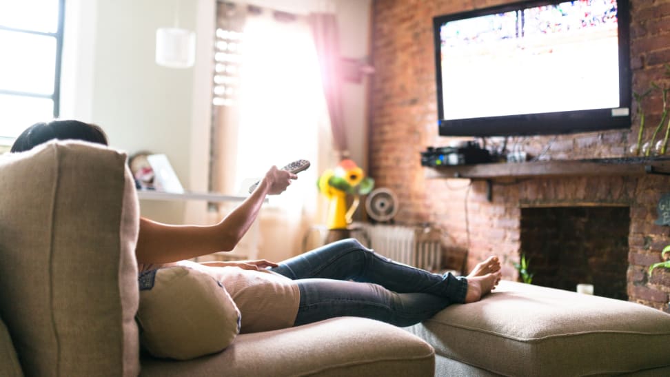 Woman watching TV on couch