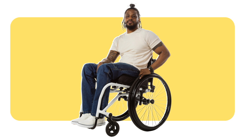A man sitting in a wheelchair wearing No Limbits Adaptive Men's Dark Wash Wheelchair Pant