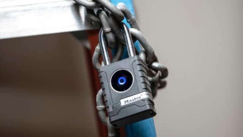 Master Lock Bluetooth Padlock affixed to a chain on a ladder