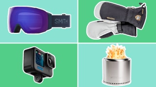 ski goggles, mittens, action camera, and fire pit on green background