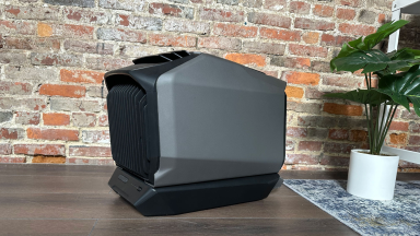 A close-up of the EcoFlow Wave 2 compact portable air conditioner in front of a brick wall.