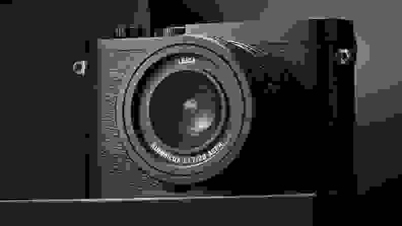 A small black camera against a black and gray background