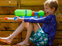 A boy shoots a Super Soakr