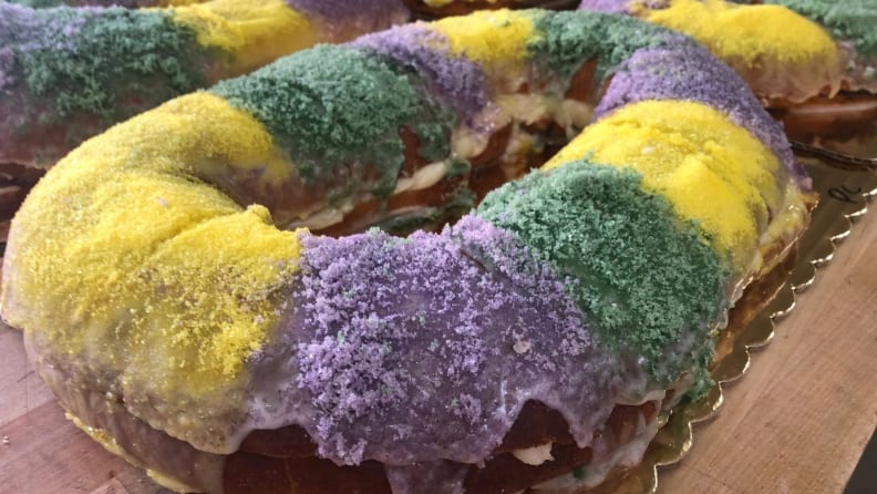 A colorful Breads on Oak vegan king cake close-up shot on a festive gold plate.