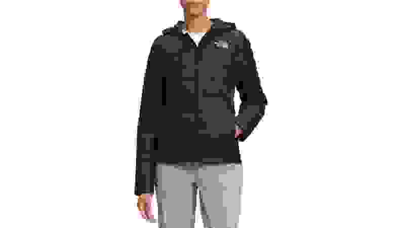 A model wearing a black, hooded, puffy, North Face jacket.