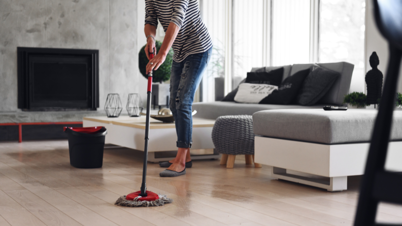 A woman mops the floor.