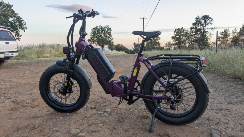 A purple Juiced JetCurrent Pro e-bike outside, on a dirt road.