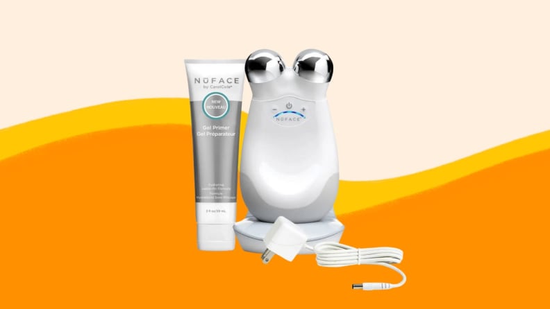 Facial roller next to bottle of product.