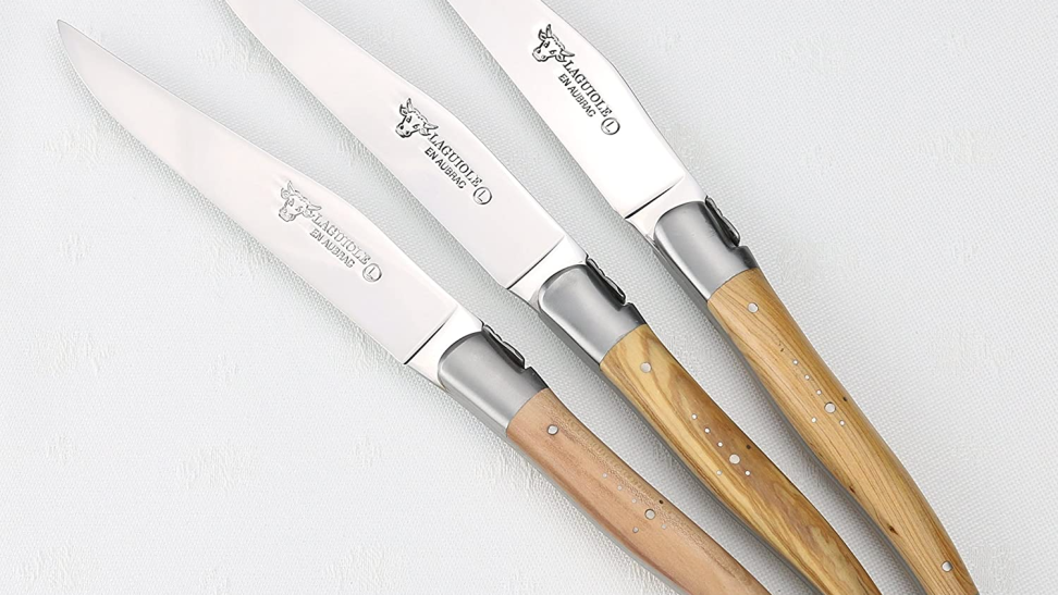 Close-up of three handcrafted Laguiole en Aubrac steak knives.