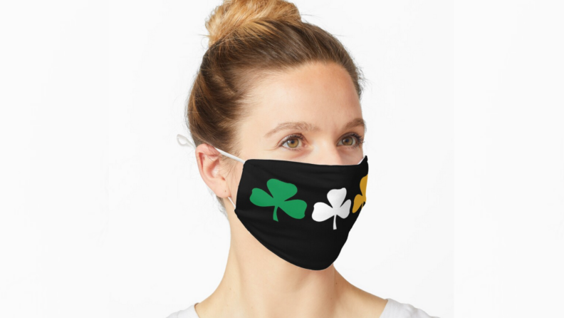 An image of a woman in a shamrock face mask.