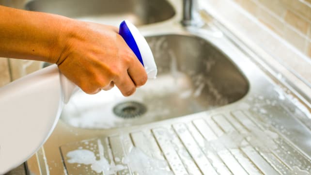Person Cleaning Sink
