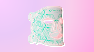 Omnilux Contour Face Mask against a purple and pink background