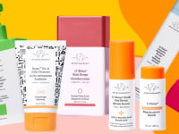 A selection of seven creams, moisturizers and beauty products against a colorful background.