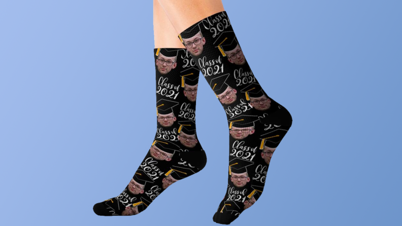 A pair of black socks with faces on them