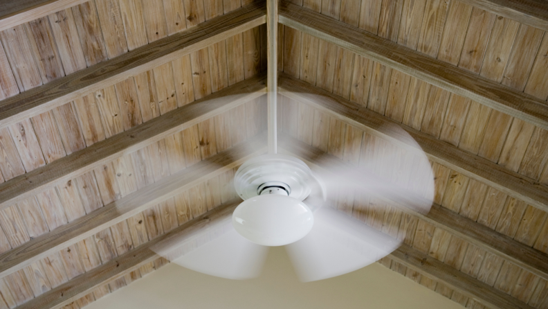 Ceiling fan spinning in motion.