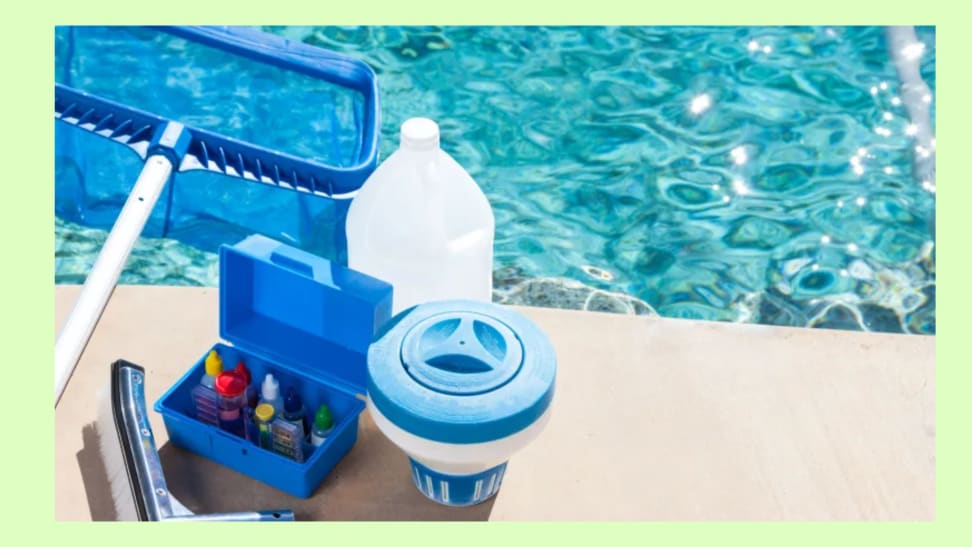 Cleaning materials for a pool sitting on the edge of a pool.