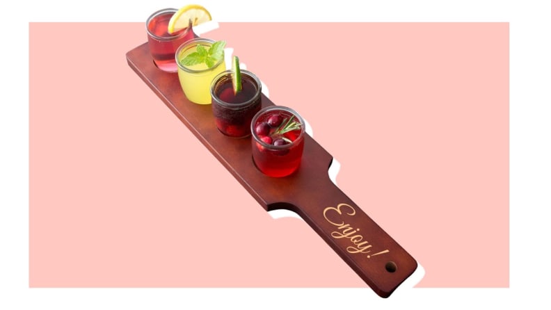 Product shot of beverage flight paddle with four drink holders.