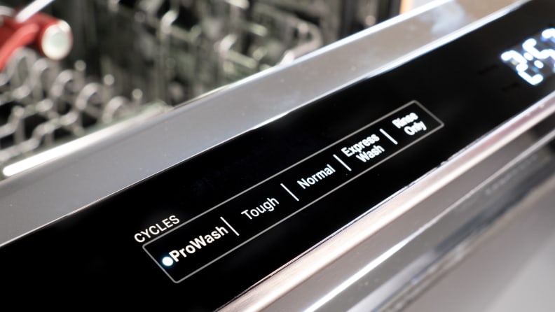 A close up of the KitchenAid KDPM804KBS dishwasher's controls, located along the top edge of its door.