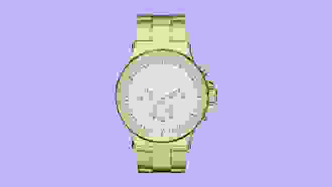 Gold watch against purple background