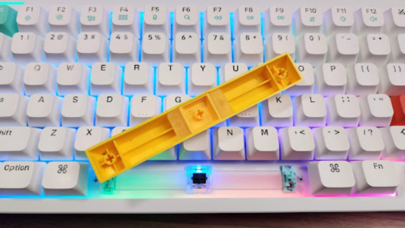 A close-up image of the spacebar of the Nuphy Halo96 removed and overturned to show the soft silicone keycap.