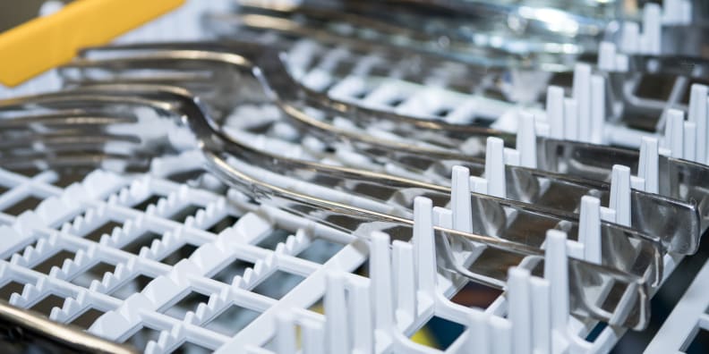 How to load a cutlery basket in a dishwasher?