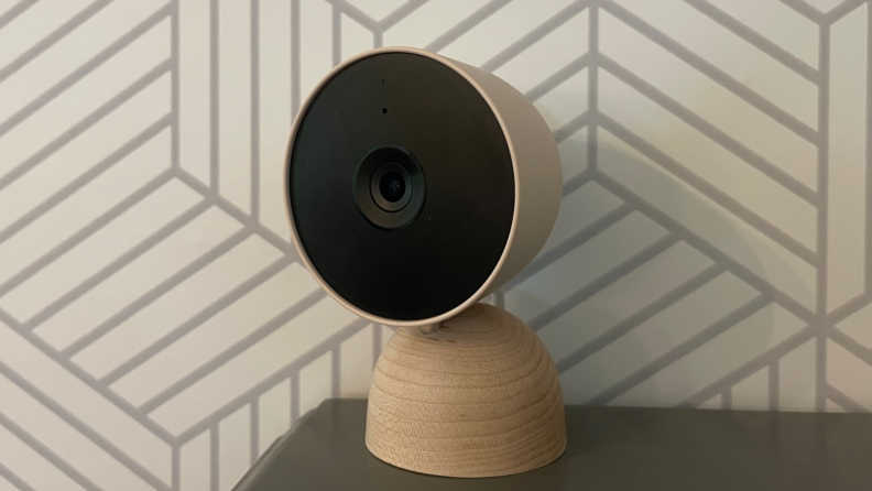 The Google Nest Cam (indoor, wired) sits on a gray desk.