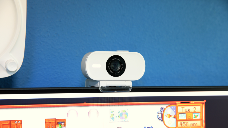 The Elgato Neo Facecam, a white webcam with rounded edges on top of a monitor