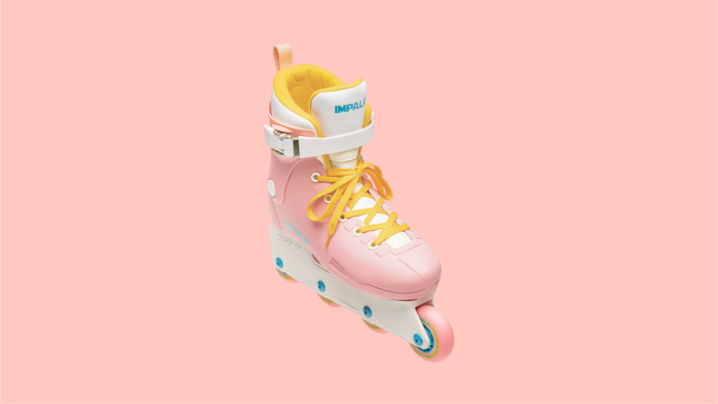 An Impala rollerblade featuring a pink finish with orange laces and white and blue accents.