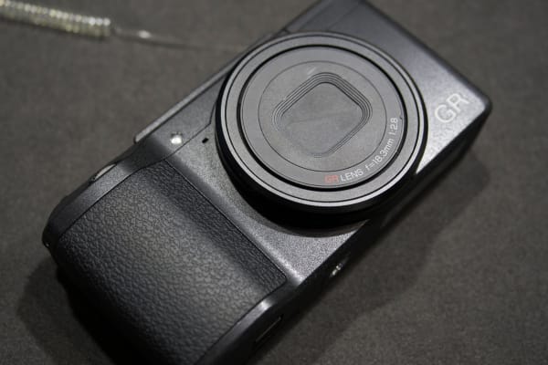 A collapsing lens means that the GR doesn't need a front cap.