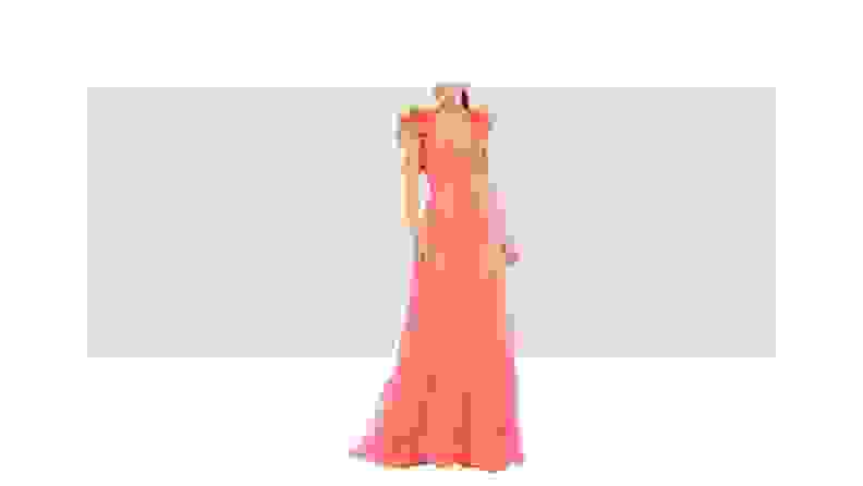 A model wearing a coral-colored gown with ruffled shoulder details and cutouts along the bodice.