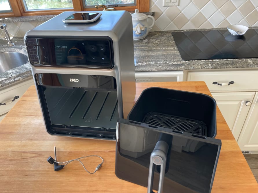 Dreo ChefMaker Combo Fryer on a wooden surface in a kitchen.