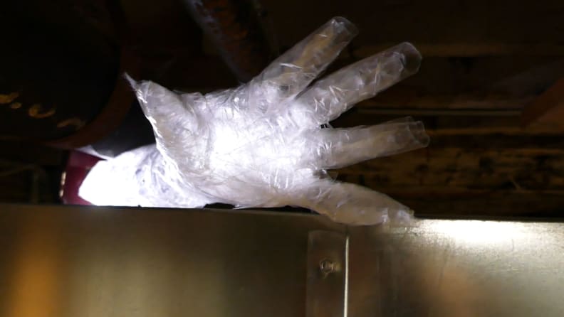 A ghostly packing tape cast hand, illuminated by a hidden light source.