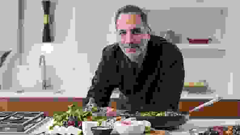 Famed chef Yotam Ottolenghi poses for a portrait in the kitchen.