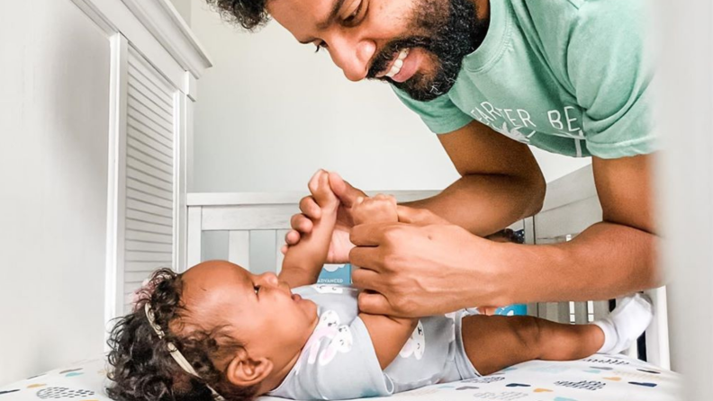 Dad changing baby.