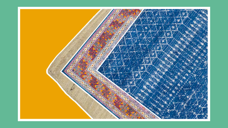 Three multicolored, patterned area rugs layered on top of each other.