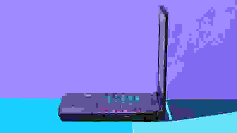 An open laptop viewed from a 90-degree angle against a blue and purple backdrop.